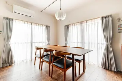 a dining room with a wooden table and chairs at jtr\u65b0\u5c0f\u5ca92\u4e01\u76ee in Tokyo