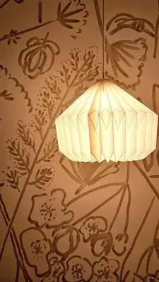 a lamp hanging from a wall with a floral pattern at jtr\u65b0\u5c0f\u5ca92\u4e01\u76ee in Tokyo