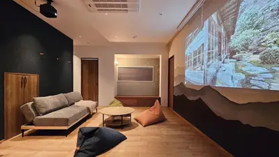 a living room with a couch and a table at jtr\u65b0\u5c0f\u5ca92\u4e01\u76ee in Tokyo