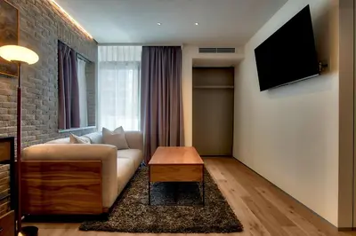 a living room with a couch and a tv at STUMP SA MinamiAzabu in Tokyo