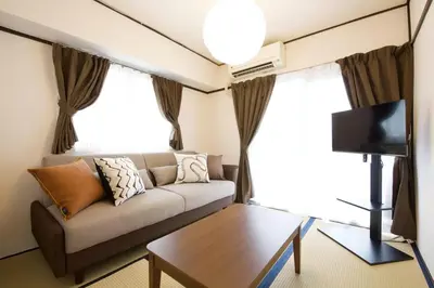 a living room with a couch and a tv at \u30b0\u30ec\u30a4\u30b9\u5411\u5cf6 302 in Tokyo