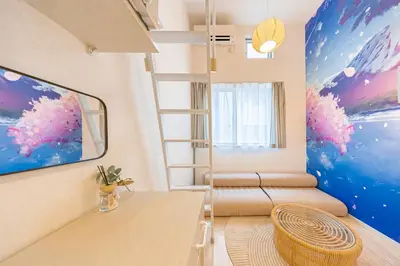 a room with a ladder and a painting on the wall at Petit Shinjuku in Tokyo
