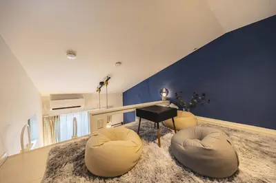 a living room with a piano and two chairs at Petit Shinjuku in Tokyo