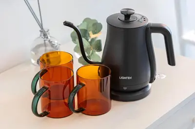 a tea kettle and two cups on a counter at Petit Shinjuku in Tokyo