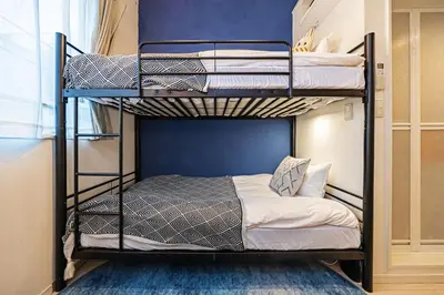 a bedroom with two bunk beds in a room at Petit Shinjuku in Tokyo
