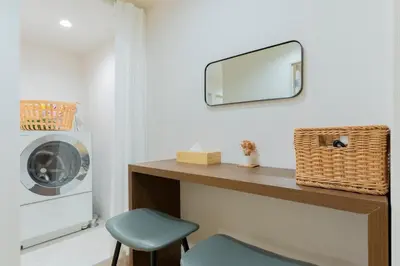 a mirror on a wall above a counter with a chair at T4U Shinjyuku in Tokyo