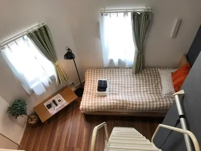 a small bedroom with a bed and two windows at 201\u53f7 \u5c71\u624b\u7ebf\u8fd1\u4e0a\u91ce\u4e00\u7ad9\u590d\u5f0f\u6e29\u99a8\u65b0\u516c\u5bd3 in Tokyo