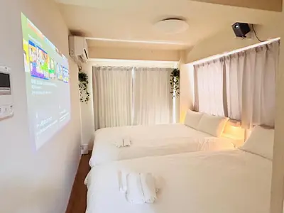 two beds in a small room with a screen at ying-Kabukicho 1F-SJ0066 in Tokyo