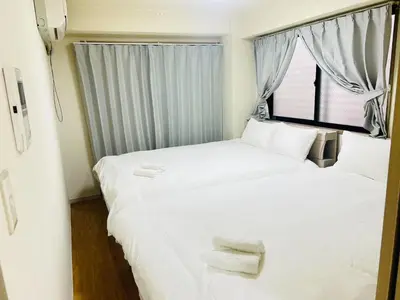 two beds in a small room with a window at ying-Kabukicho 1F-SJ0066 in Tokyo