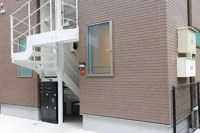 a staircase on a brick wall with a building at Room #101 - Cozy Stay Higashi Ikebukuro in Tokyo