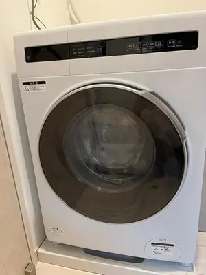 a white washing machine sitting in a room at Room #101 - Cozy Stay Higashi Ikebukuro in Tokyo