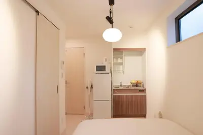 a kitchen with a white refrigerator and a window at Room #101 - Cozy Stay Higashi Ikebukuro in Tokyo