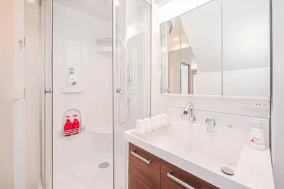 a white bathroom with a shower and a sink at Stay \u6b4c\u821e\u4f0e\u753a A in Tokyo