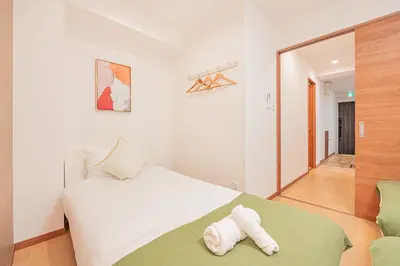 a bedroom with a white bed and a mirror at Stay \u6b4c\u821e\u4f0e\u753a A in Tokyo