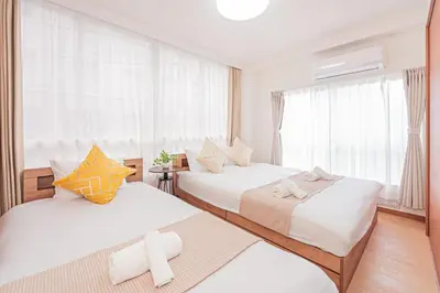 a hotel room with two beds and a window at Stay \u6b4c\u821e\u4f0e\u753a A in Tokyo