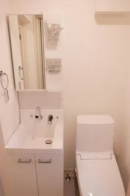 a white bathroom with a toilet and a sink at Room #202 - Cozy Stay Higashi Ikebukuro in Tokyo