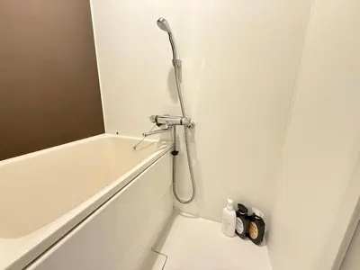 a shower in a bathroom with a white tub at Shinjuku downtown B2 in Tokyo