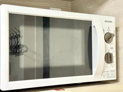 a white microwave oven sitting on top of a counter at Shinjuku downtown B2 in Tokyo