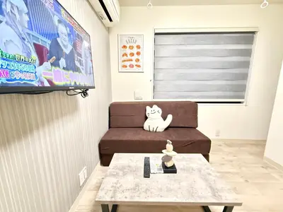 a living room with a couch and a tv at Shinjuku downtown B2 in Tokyo