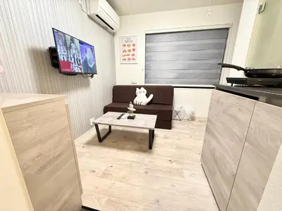 a living room with a couch and a coffee table at Shinjuku downtown B2 in Tokyo