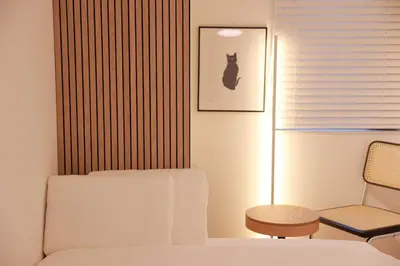 a bedroom with a bed and a chair and a picture of a cat at Room #301 - Cozy Stay Higashi Ikebukuro in Tokyo