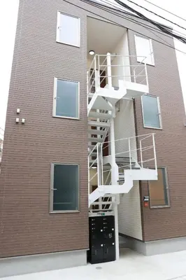 a building with a spiral staircase on the side of it at Room #302 - Cozy Stay Higashi Ikebukuro in Tokyo