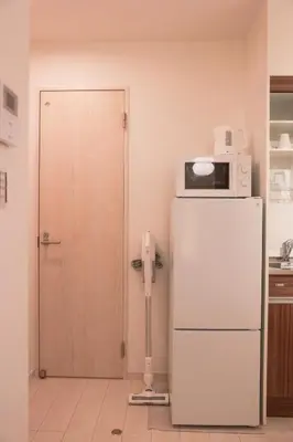 a microwave on top of a refrigerator in a kitchen at Room #302 - Cozy Stay Higashi Ikebukuro in Tokyo