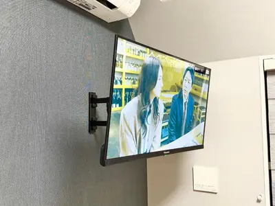 a flat screen tv hanging on a wall at Shinjuku downtown C2 in Tokyo