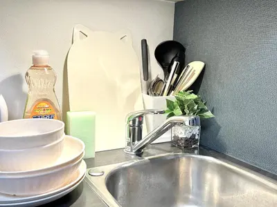 a kitchen counter with a sink and a counter top with dishes at Shinjuku downtown C2 in Tokyo