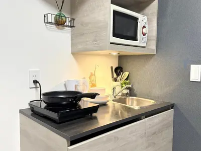 a kitchen with a sink and a microwave at Shinjuku downtown C2 in Tokyo