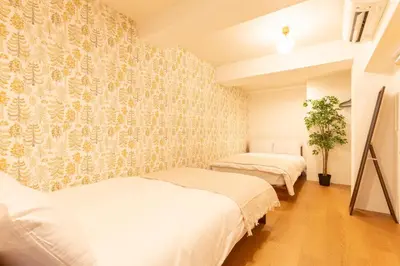 two beds in a room with a wall at Yadori\u795e\u697d\u5742 in Tokyo