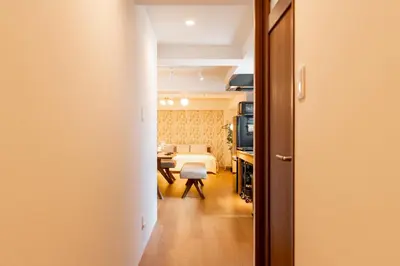 a hallway leading to a living room with a table at Yadori\u795e\u697d\u5742 in Tokyo