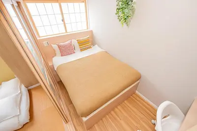 a small bed in a room with a window at Komorebi Asakusa Cozy 4P Stay The 77 House Tokyo in Tokyo