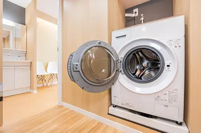 a washing machine is hanging on a wall at Komorebi Asakusa Cozy 4P Stay The 77 House Tokyo in Tokyo