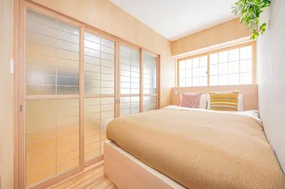 a bedroom with a large bed and a window at Komorebi Asakusa Cozy 4P Stay The 77 House Tokyo in Tokyo