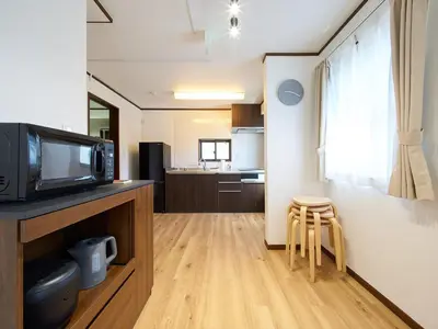 a living room with a television and a kitchen at The Prime TOKYO SKYTREE in Tokyo