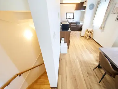 a living room with a table and a surfboard at The Prime TOKYO SKYTREE in Tokyo