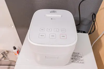 a white computer sitting on top of a counter at Komorebi Asakusa A5 Cozy 4P StayThe 77 House Tokyo in Tokyo