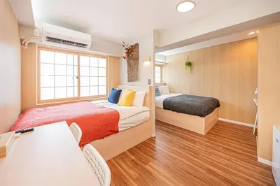 a bedroom with two beds and a desk and a window at Komorebi Asakusa A5 Cozy 4P StayThe 77 House Tokyo in Tokyo