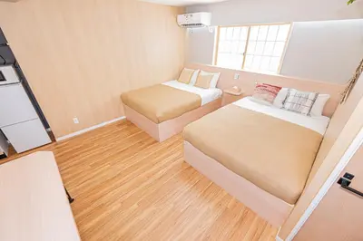 a small room with two beds and a window at Komorebi Asakusa A5 Cozy 4P StayThe 77 House Tokyo in Tokyo