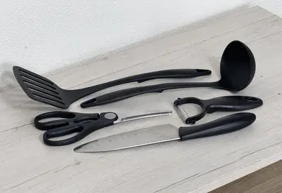 a group of kitchen utensils sitting on a table at \u30a2\u30b9\u30d4\u30a2302 in Tokyo