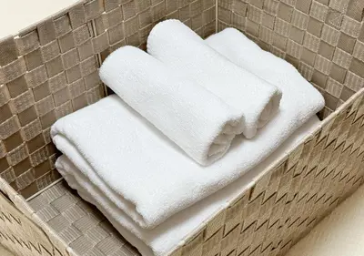 three white towels sitting on top of a basket at \u30a2\u30b9\u30d4\u30a2302 in Tokyo