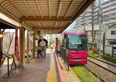 a pink train is parked at a train station at \u30a2\u30b9\u30d4\u30a2302 in Tokyo