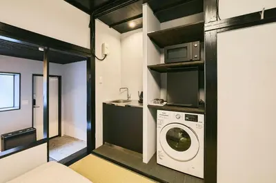 a kitchen with a washing machine and a microwave at \u3077\u3075\u304b\u5186\u5fb3\u9418\u30f6\u6df5 in Tokyo