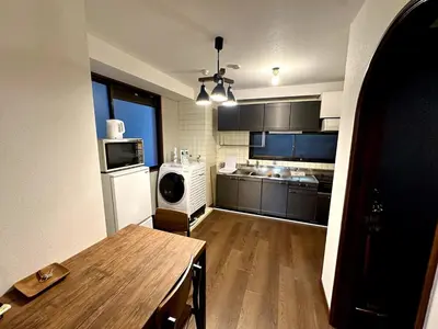 a kitchen with a wooden table in a room at AM's 501 5 min to Ikebukuro 13 min to Shinjuku Station 19 min to Shibuya Station in Tokyo