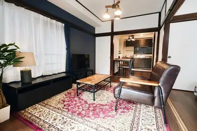 a living room with a table and a chair at AM's 501 5 min to Ikebukuro 13 min to Shinjuku Station 19 min to Shibuya Station in Tokyo