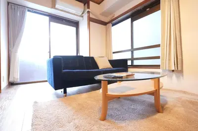 a living room with a couch and a coffee table at AM's 701 Ikebukuro 5 min Shinjuku Station 13 min Shibuya Station 19 min in Tokyo