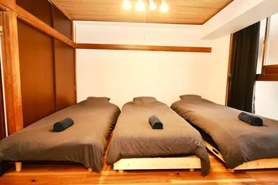 two beds sitting next to each other in a room at AM's 701 Ikebukuro 5 min Shinjuku Station 13 min Shibuya Station 19 min in Tokyo