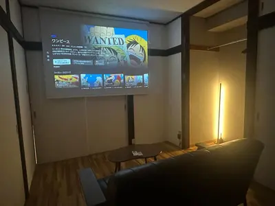 a room with a large screen on a wall at AM's 502 Movie 5 min to Ikebukuro 13 min to Shinjuku Station 19 min to Shibuya Station with coworking space in Tokyo