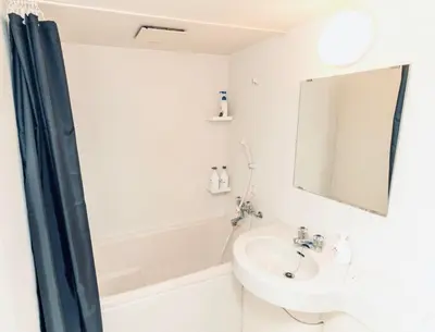 a bathroom with a sink and a tub and a mirror at AM's 502 Movie 5 min to Ikebukuro 13 min to Shinjuku Station 19 min to Shibuya Station with coworking space in Tokyo